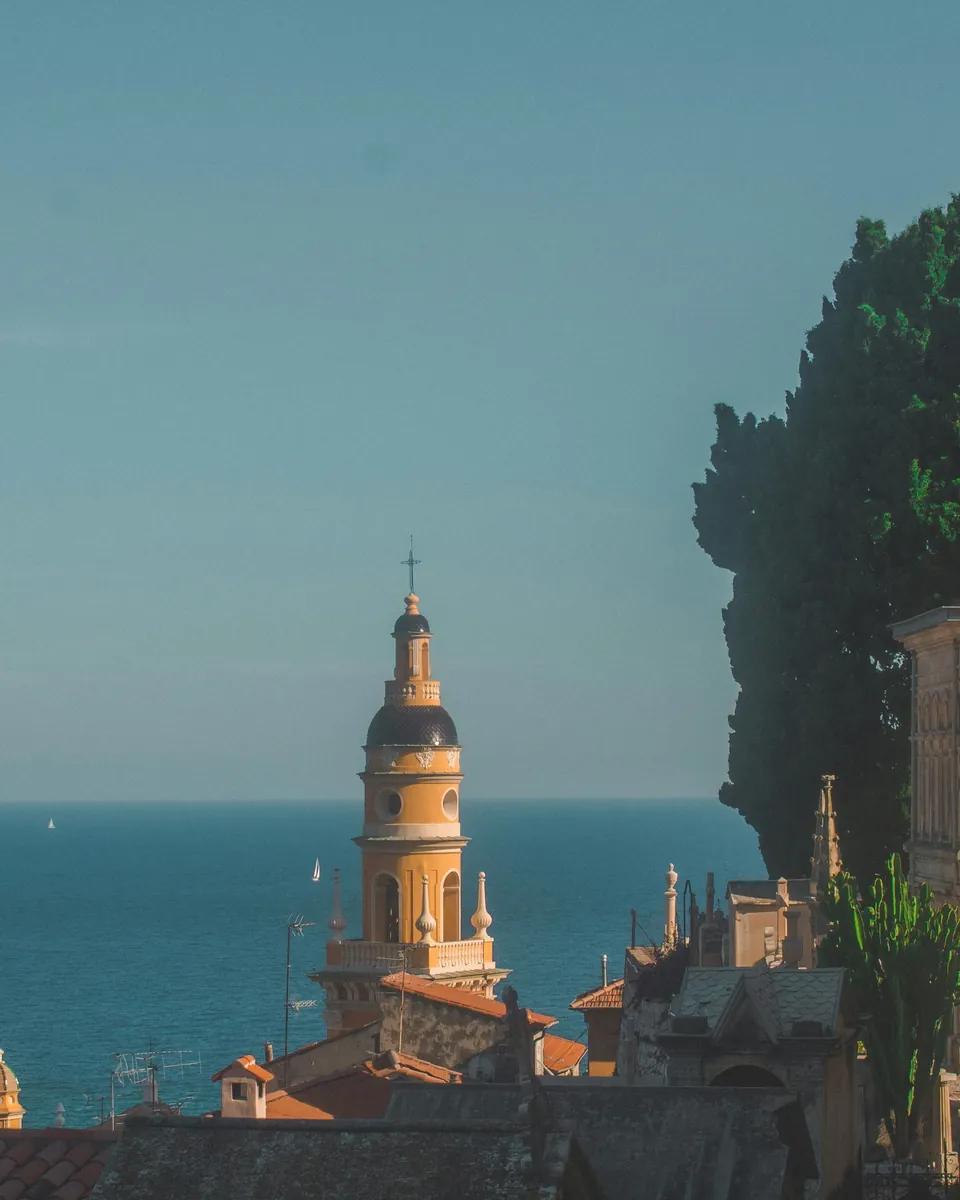 Menton's church bell tower against the Mediterranean