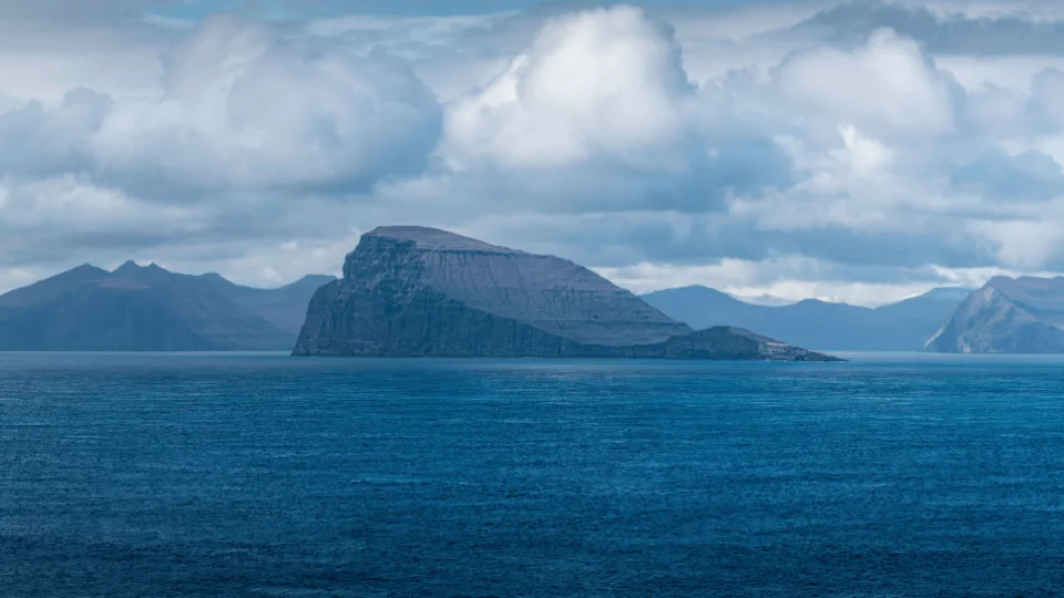 Morning haze over sea cliffs and a calm bay